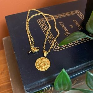 Gold necklace with Cupid pendant